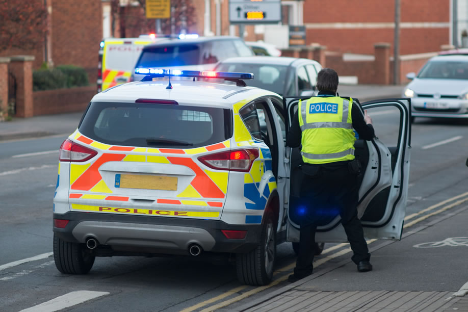 Police getting into a police car