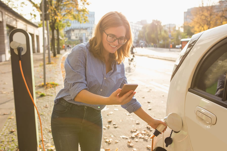 Woman Charging Her Electric Vehicle