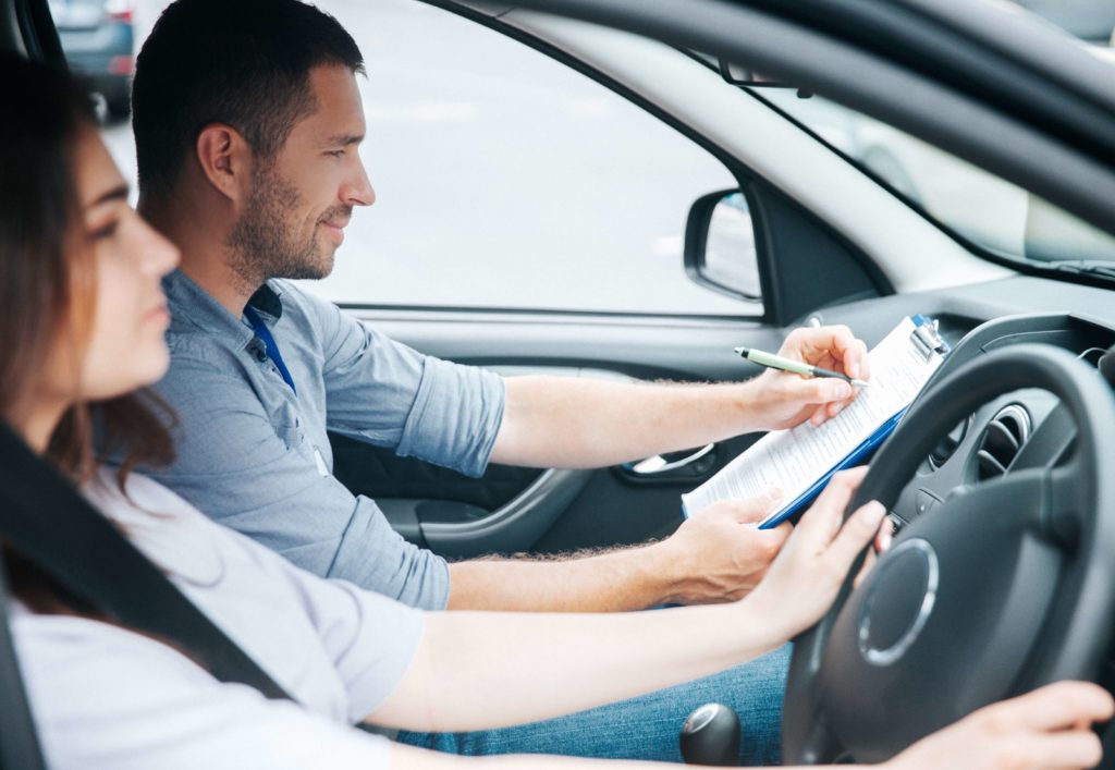 learner driver taking a driving test with examiner in passenger seat