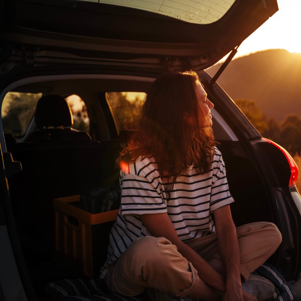 sitting at the boot of the car admiring sunset