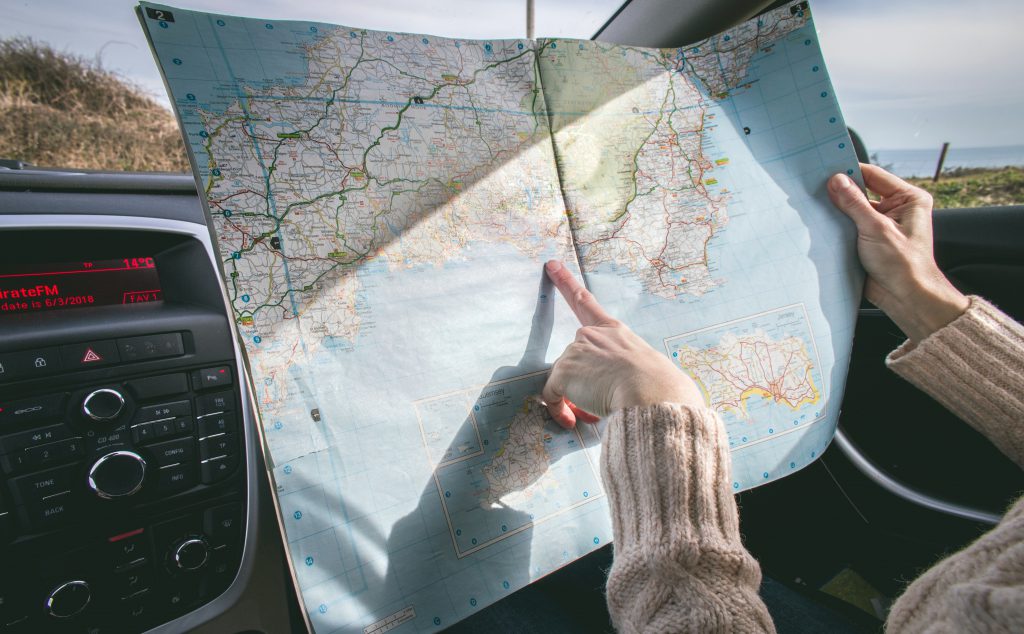 Woman using map to plan driving route to encourage being a confident driver.