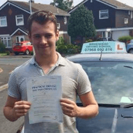 Young Male Learner Driver Holding a Driving Test Certificate