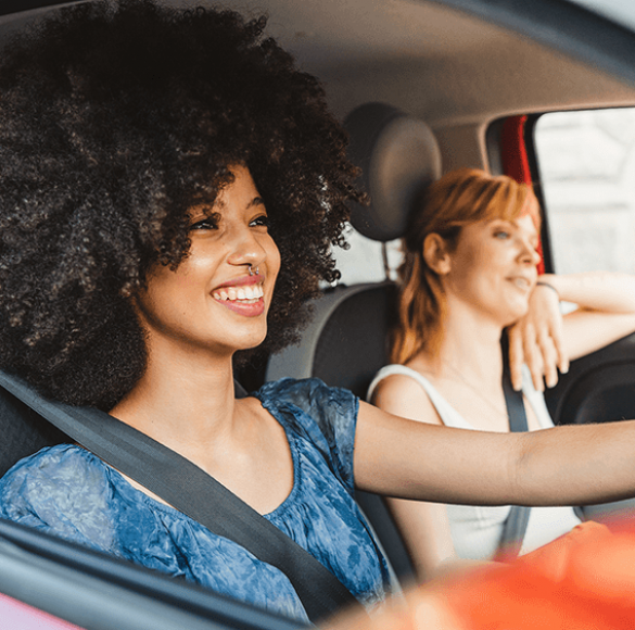 Two women in car smiling