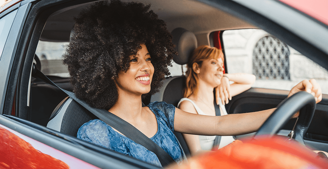 Woman and friend in car learning to drive