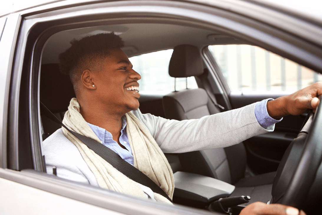 male learner driver smiling looking ahead