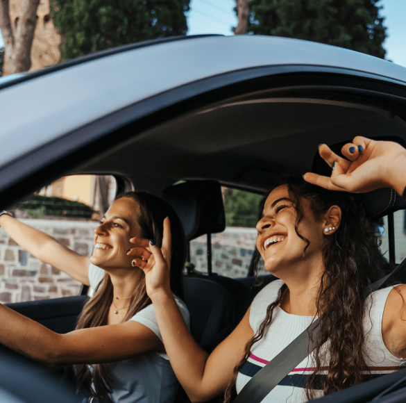 Two women in car smiling
