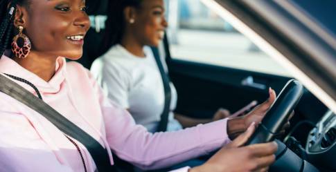 Woman and friend in car learning to drive