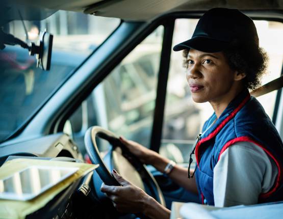 Courier making a food delivery with car in background