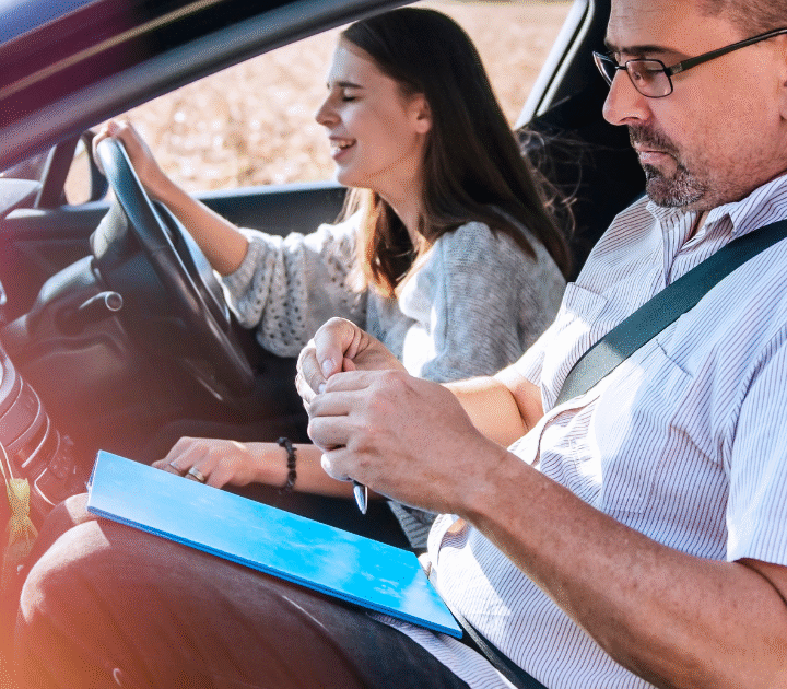 driving instructor with female driver