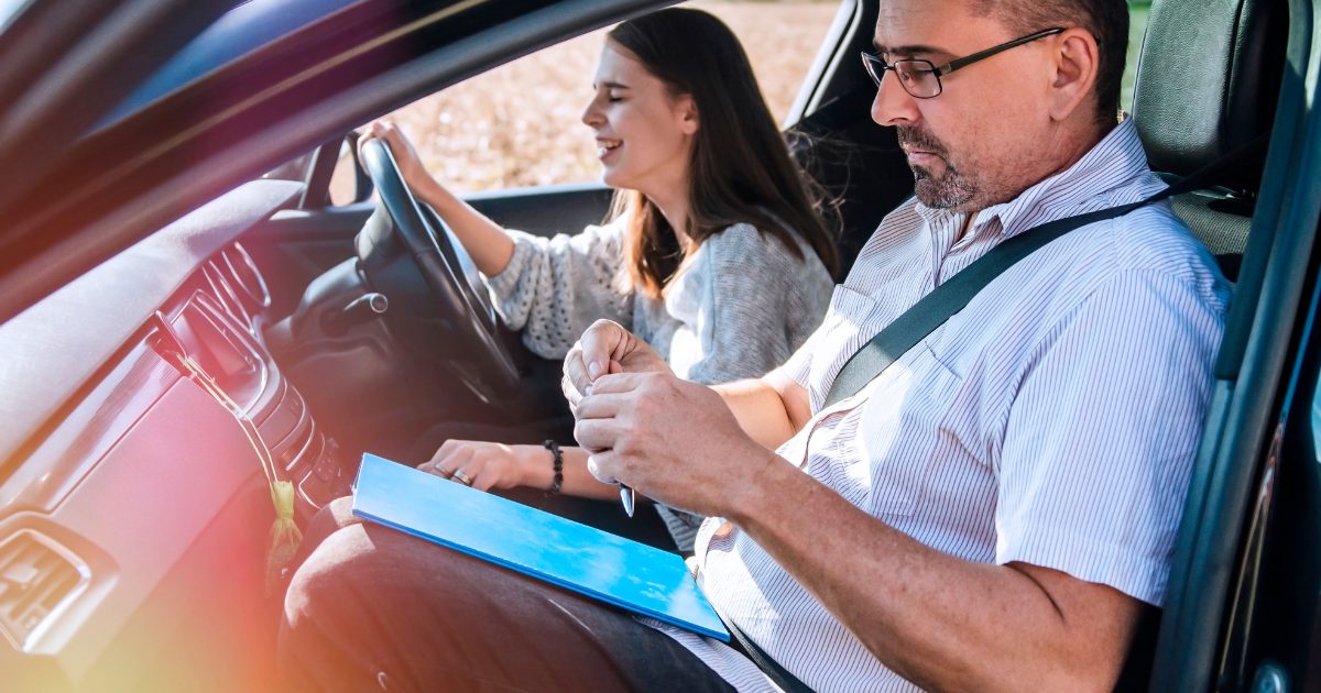 female driver with male driving examiner