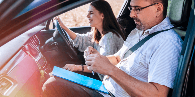 female driver with male driving examiner
