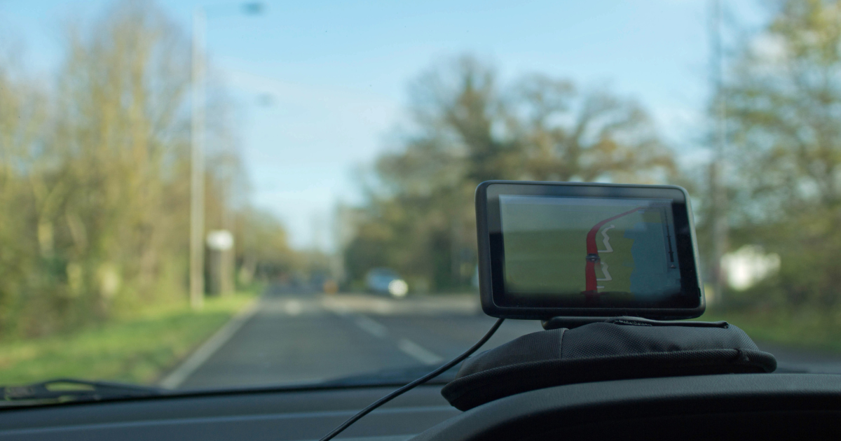 car driving on road using sat-nav