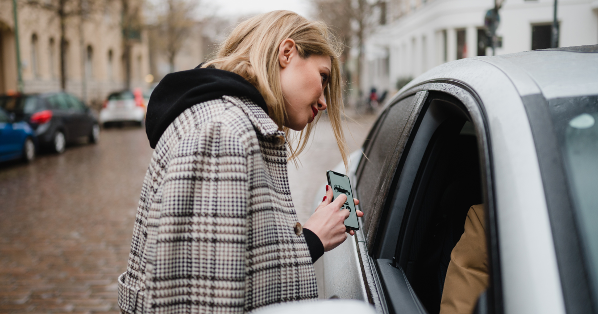 woman showing taxi driver her booking