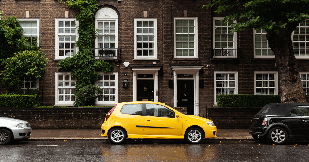 Image of yellow car parked outside a house