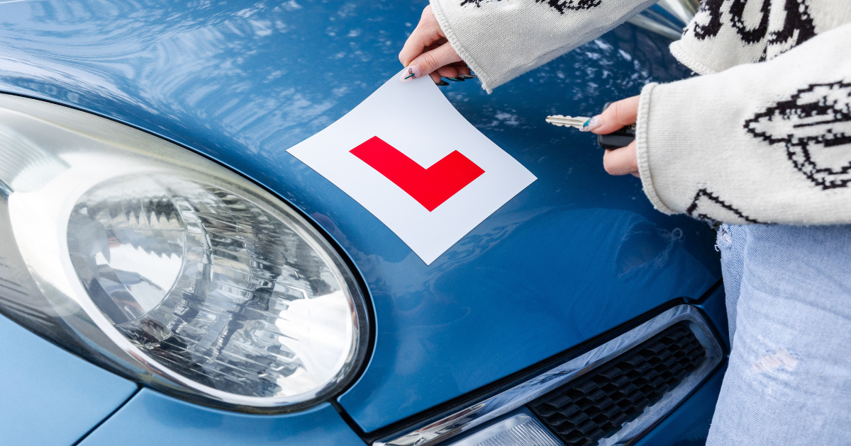 someone putting a L badge on their car