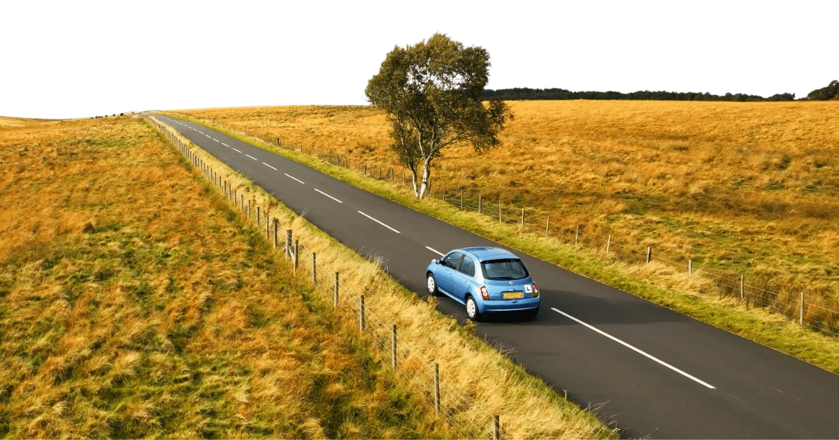 Image of a car driving through a country road