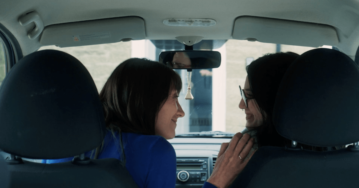 mother and daughter in the front of a car