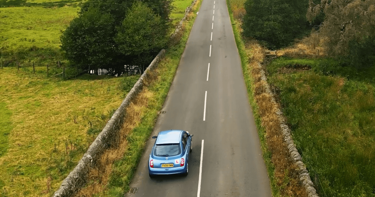 Image of car driving on road