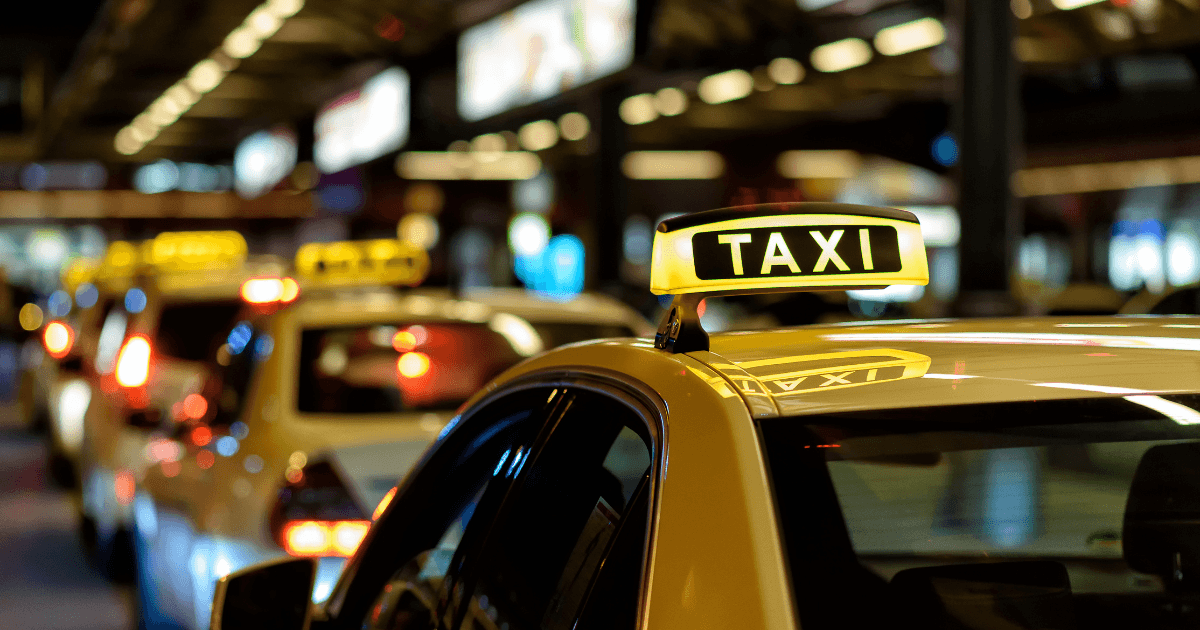 Image of taxis parked outside of airport