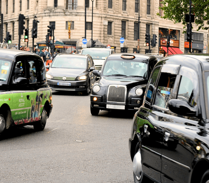 Black taxi cabs on a busy road