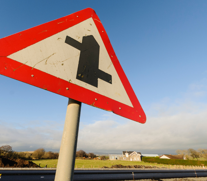 triangular road sign depicting a junction ahead